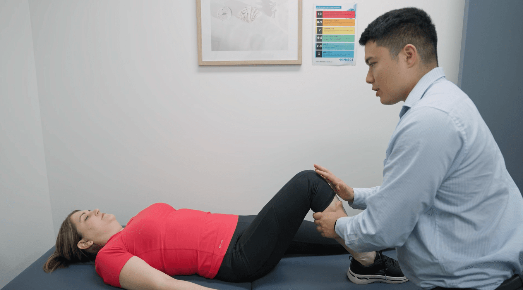 KINNECT clinician assessing a candidate's knee and lower-limb range of motion in a clinic room