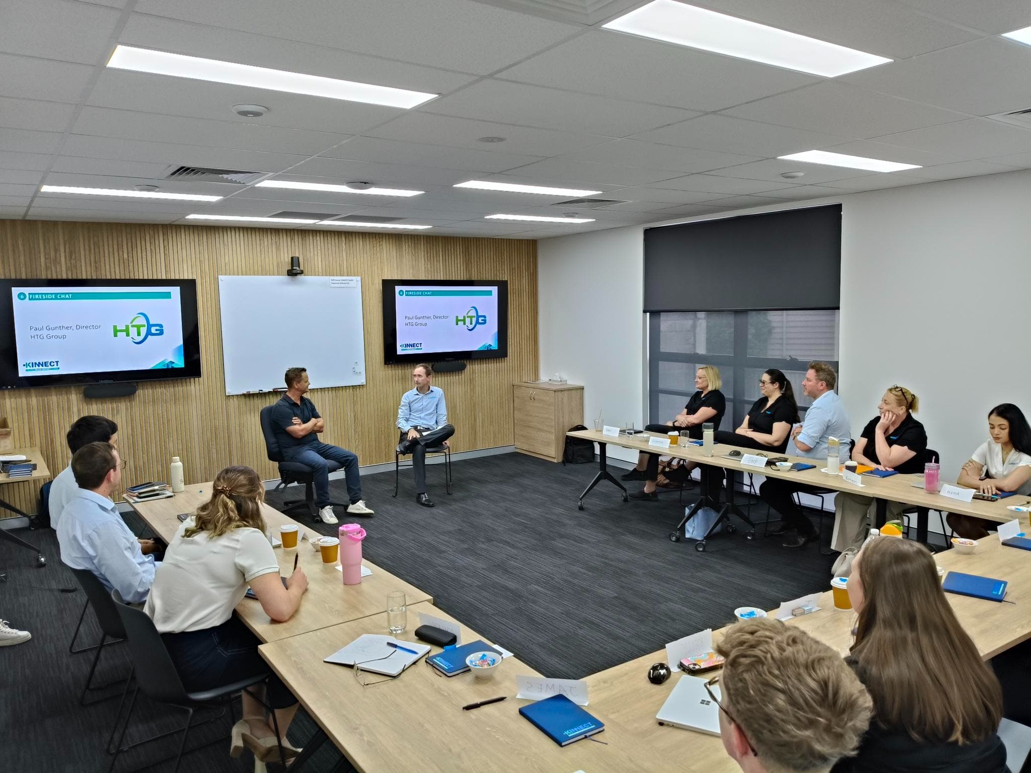 2025 KINNECT ELP Kick-Off fireside chat with Paul Gunther from HTG Group and the graduate cohort seated around the table