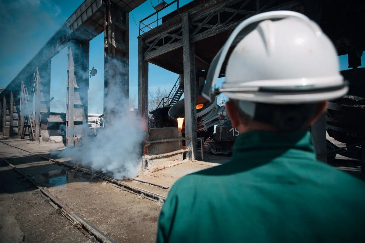 Worker wearing a hard hat at an industrial site — illustrative stock photograph