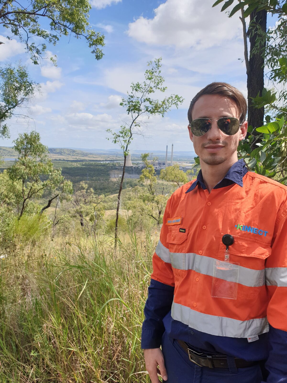 A KINNECT Allied Health consultant in hi-vis above a regional Queensland mine site